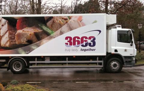 3663 lorry with food pictured on the side, driving past on a wet road.