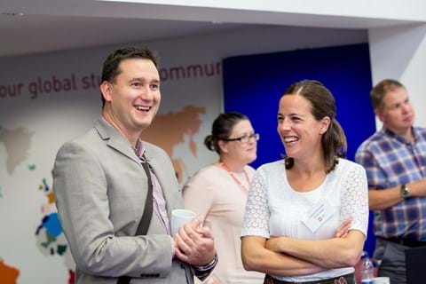 Delegate laughing with OR Society staff members