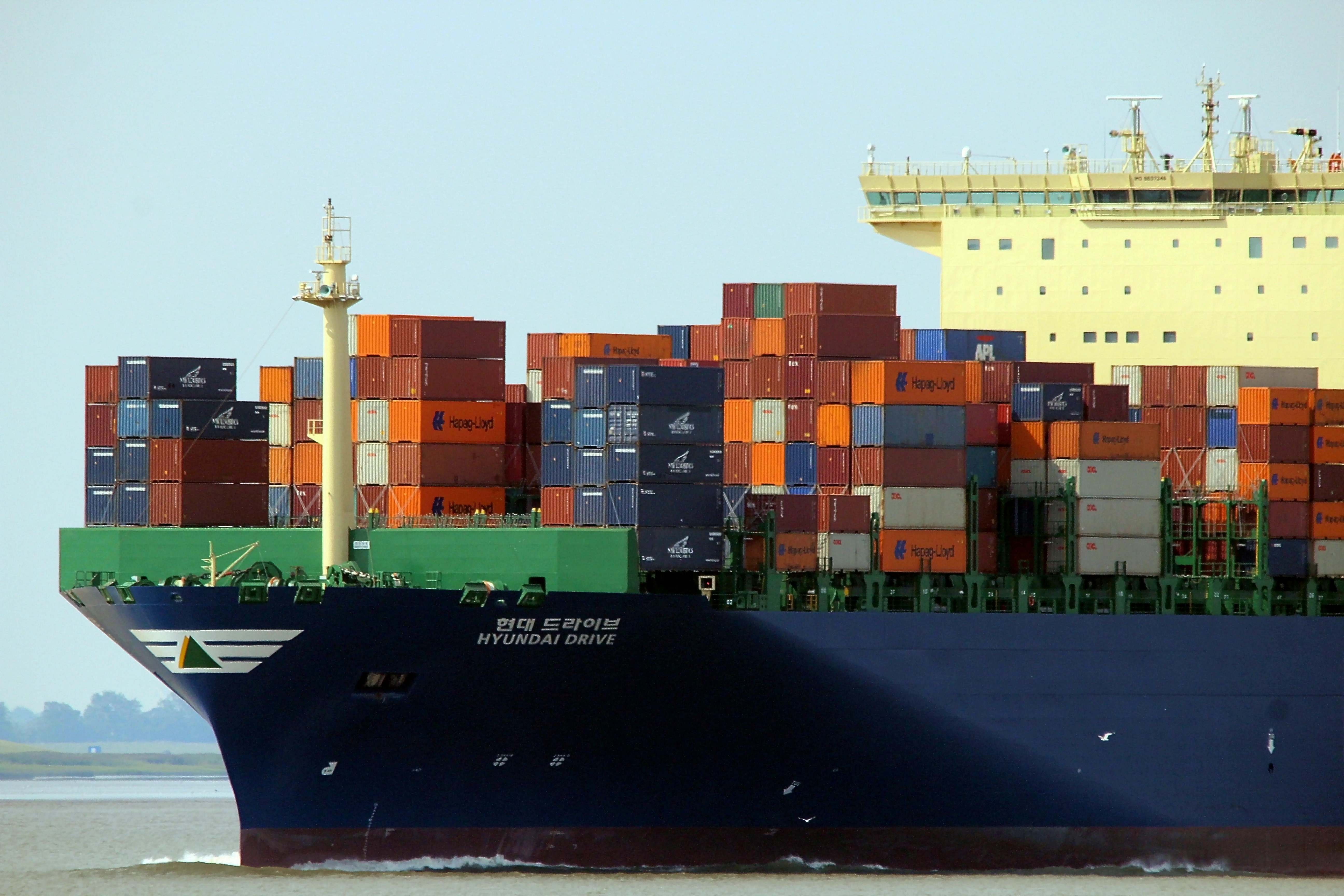 Large container ship out at sea piled with shipping containers.