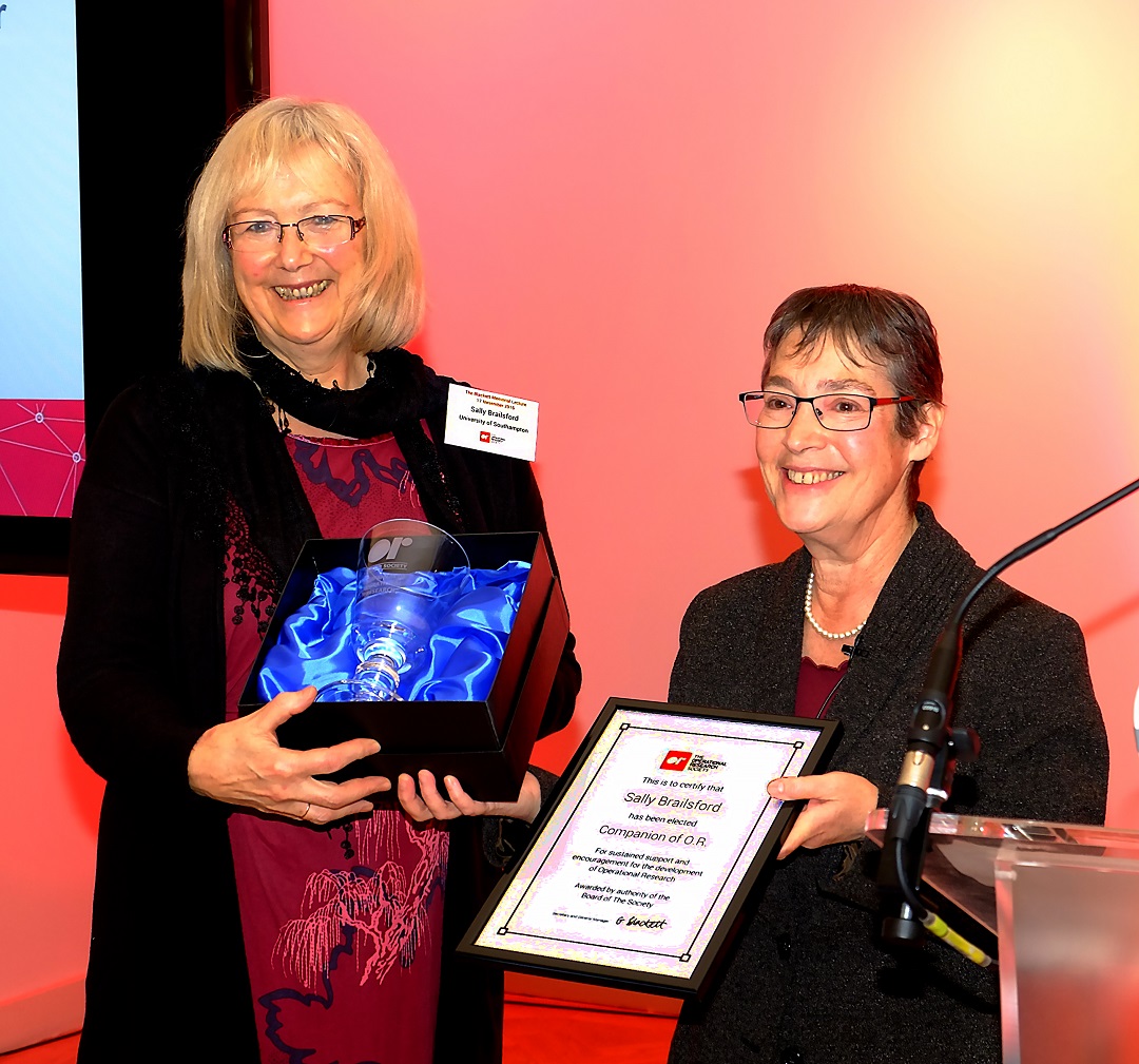 Sally Brailsford being awarded Companion of OR 2016 with Ruth Kaufman