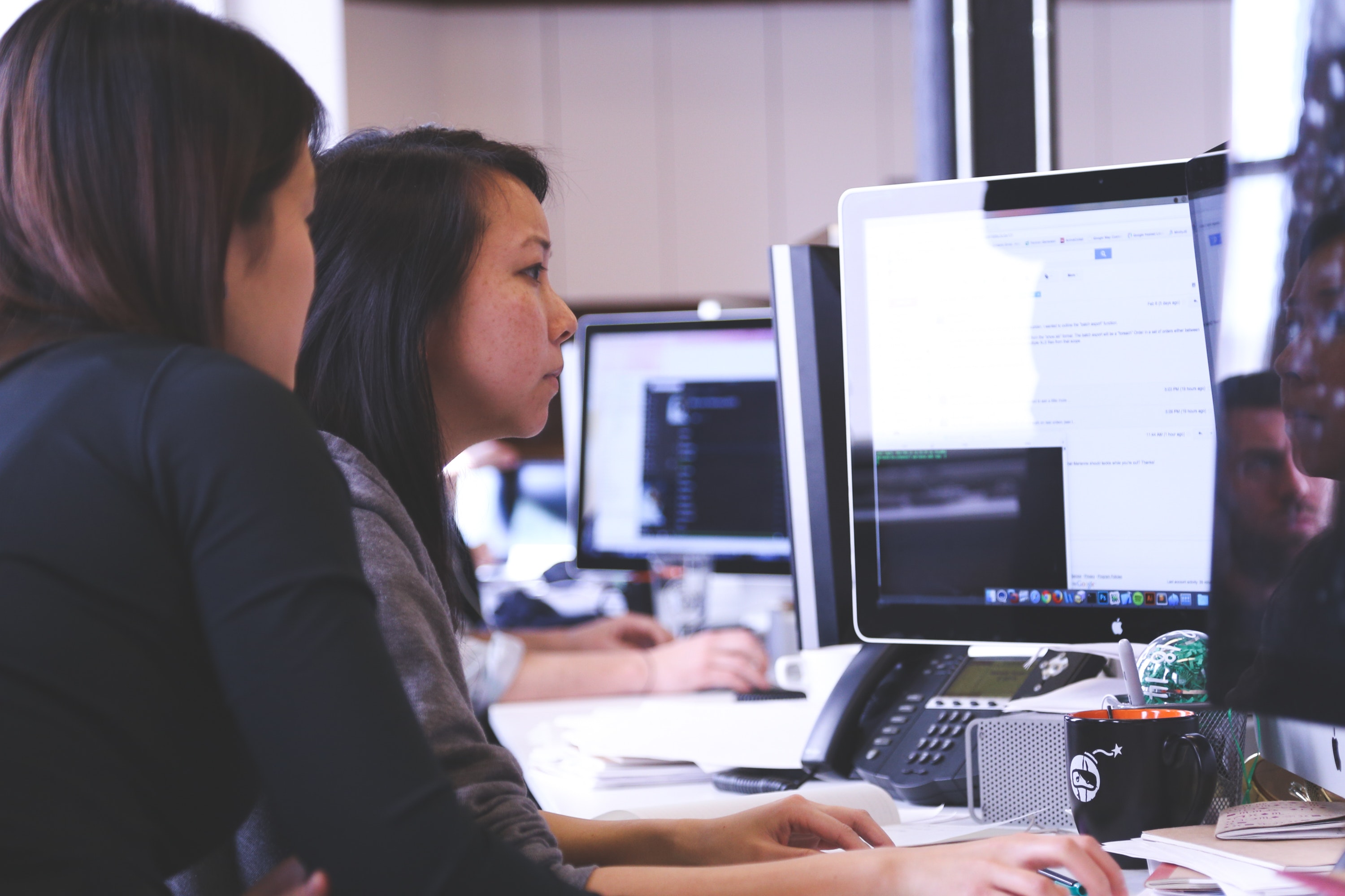 Two females at computer workstation