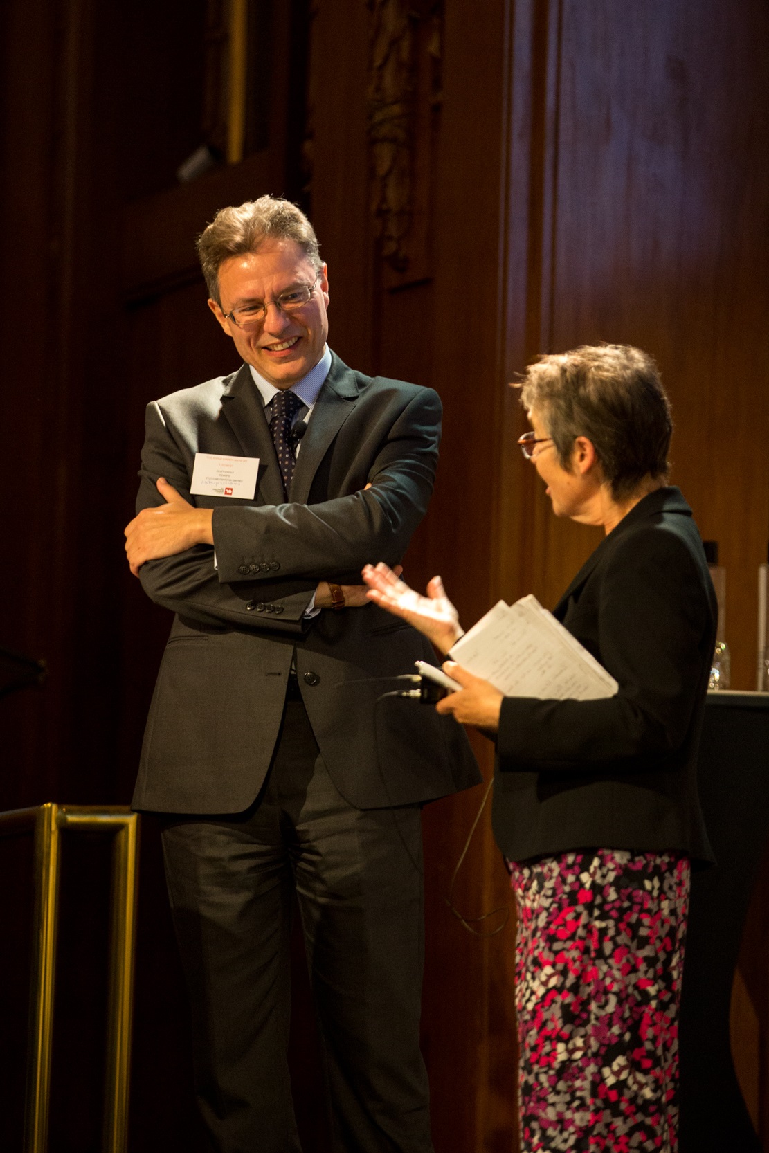 Ruth Kaufman discussing with speaker at Analytics Summit