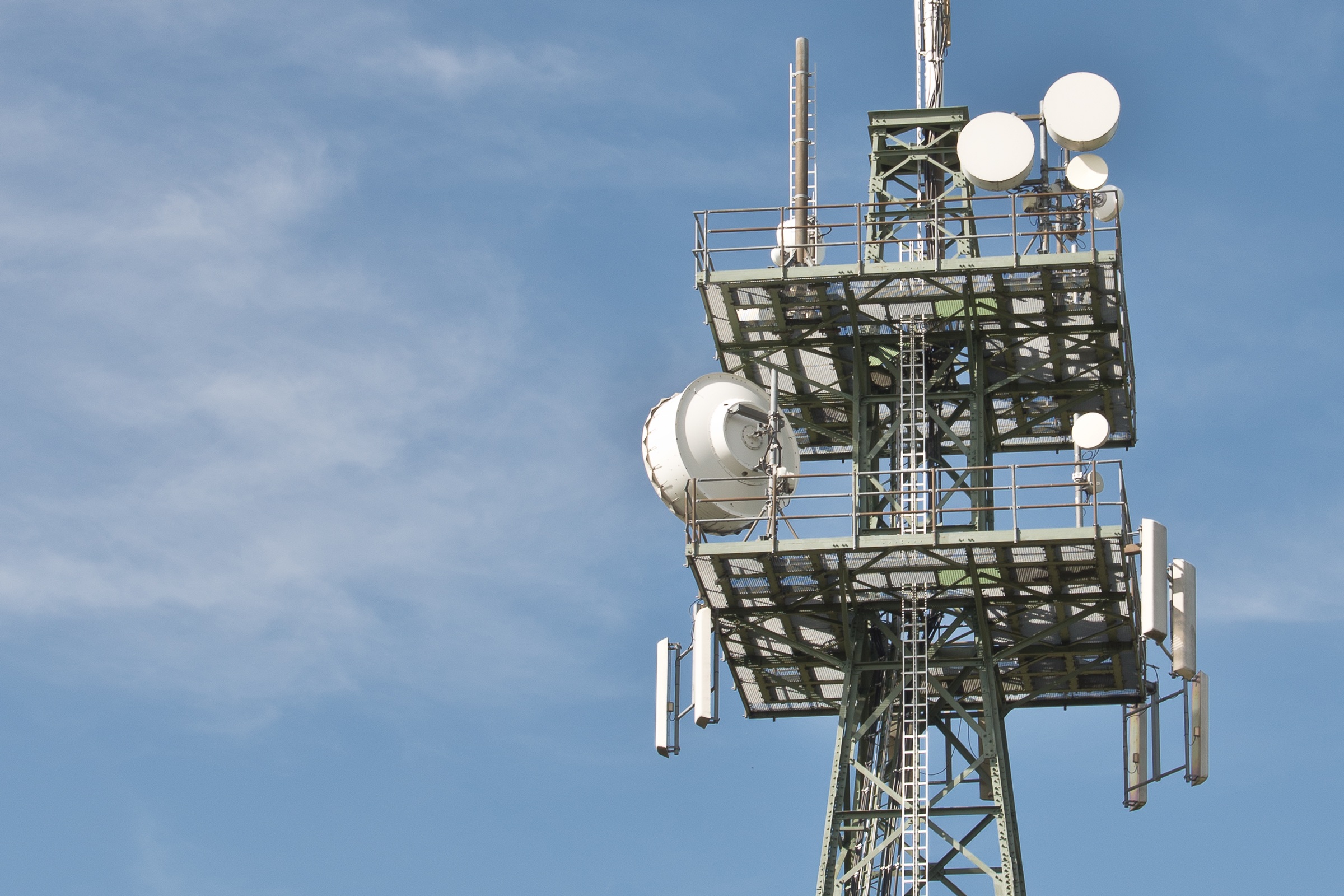 Radio mast with blue sky behind