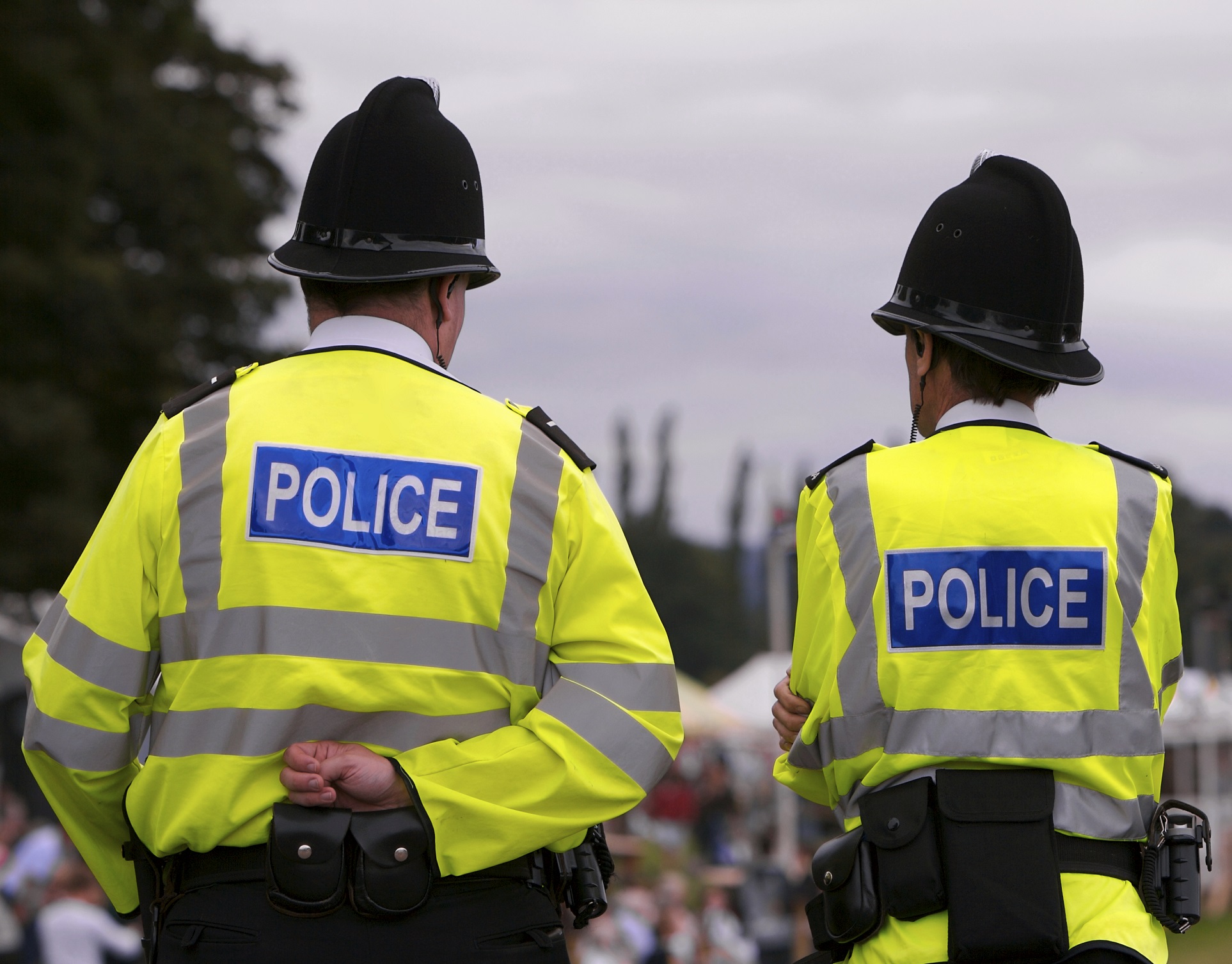 Two British police constables in luminous jackets