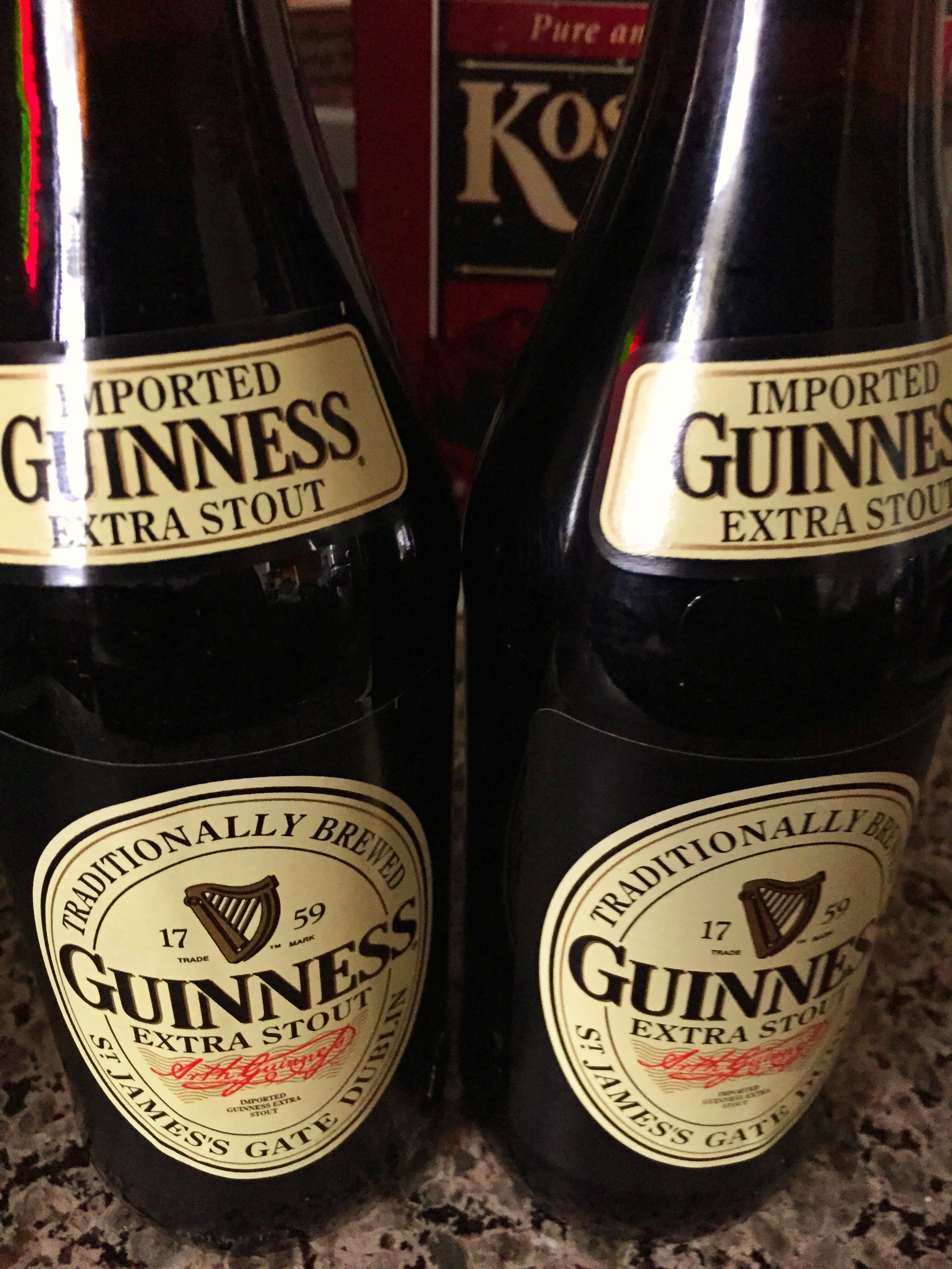 Two bottles of Guiness Extra Stout