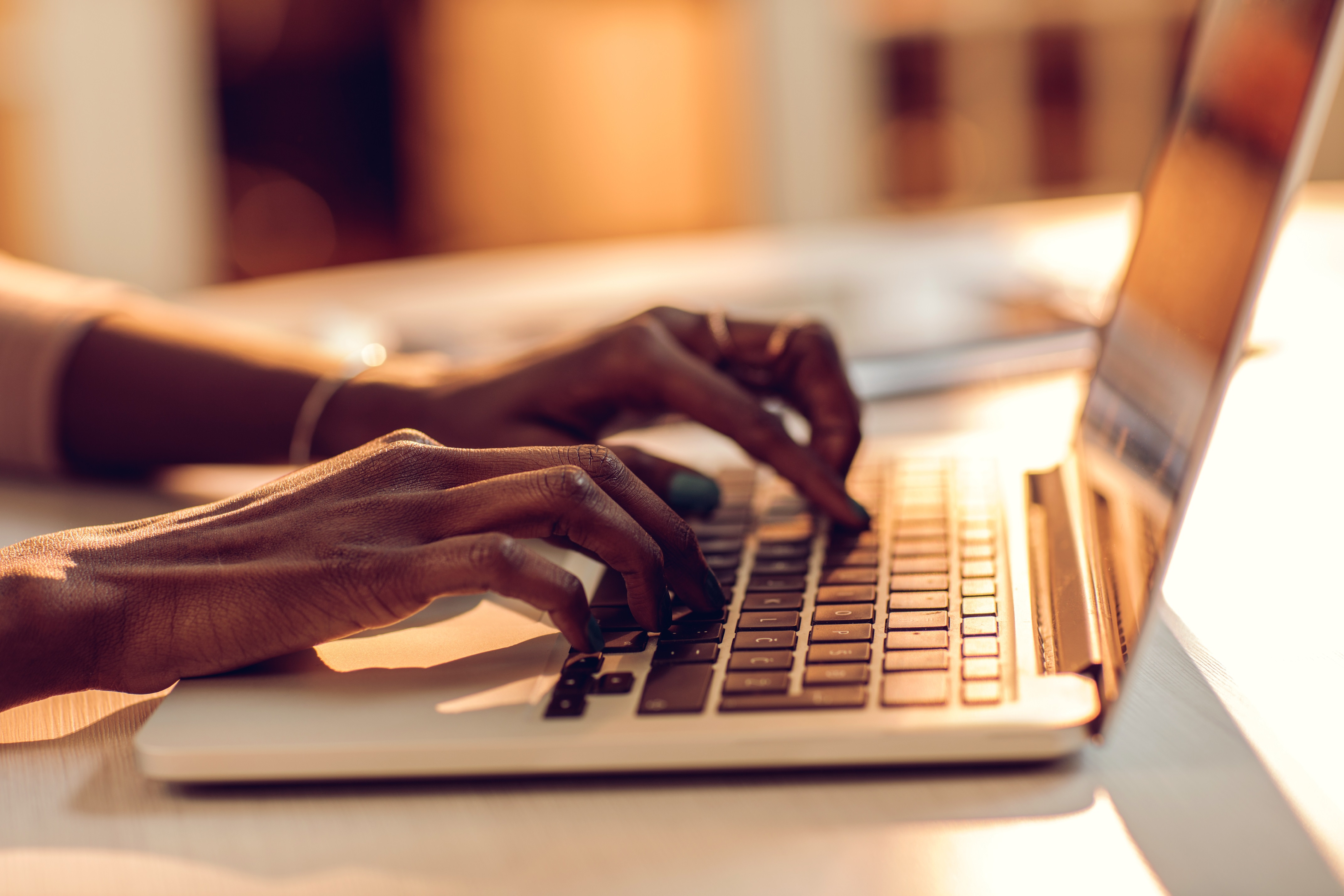 Hands typing at keyboard