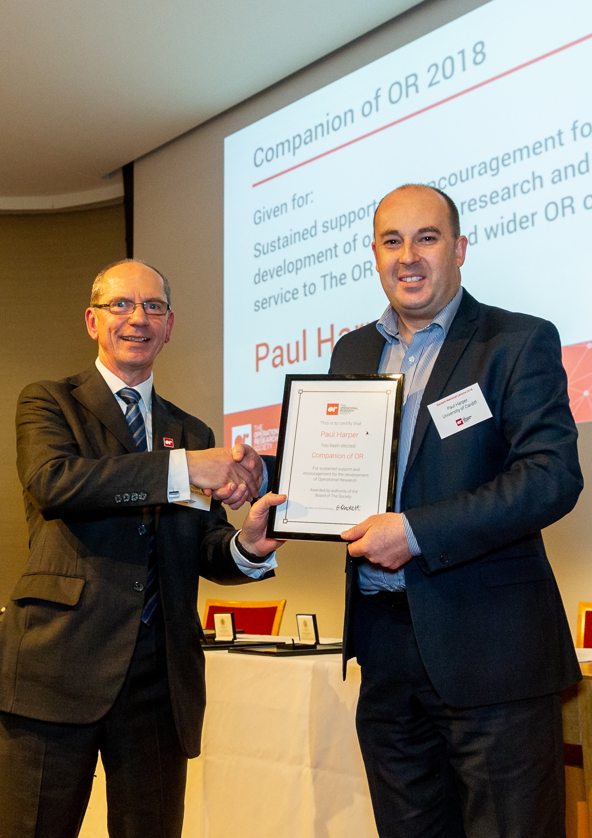 Paul Harper being awarded Companion of OR 2018 with John Hopes