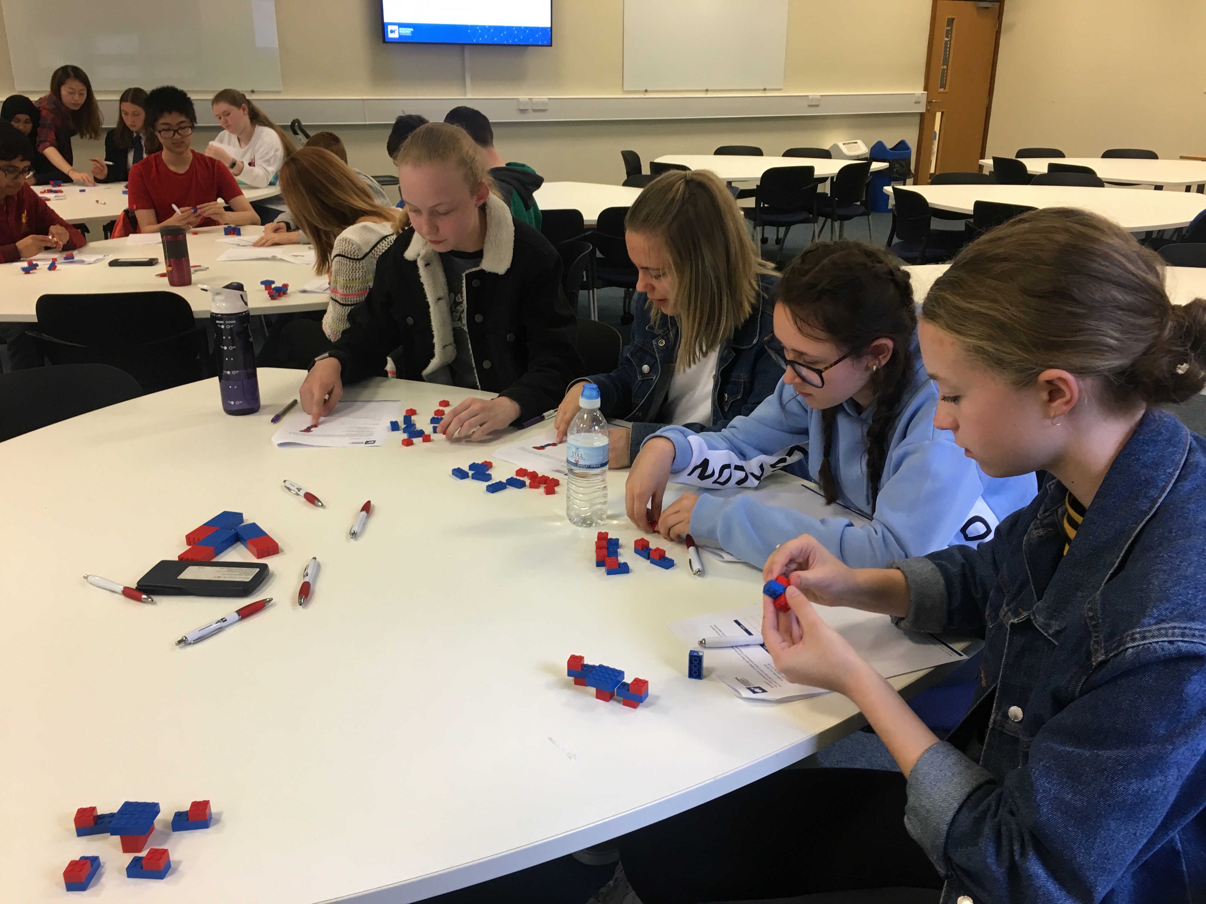 Female students participating in the lego challenge