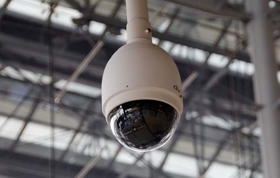 CCTV Camera with 360 degree vision hangs from ceiling in transport hub