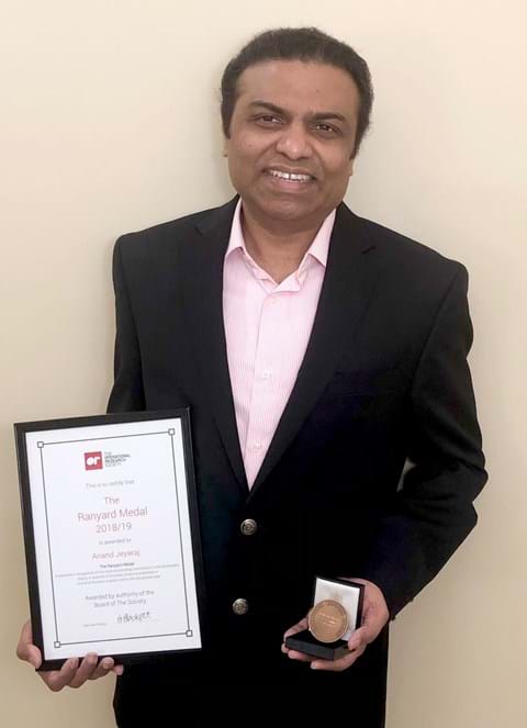 Anand Jeyaraj holding his certificate and medal